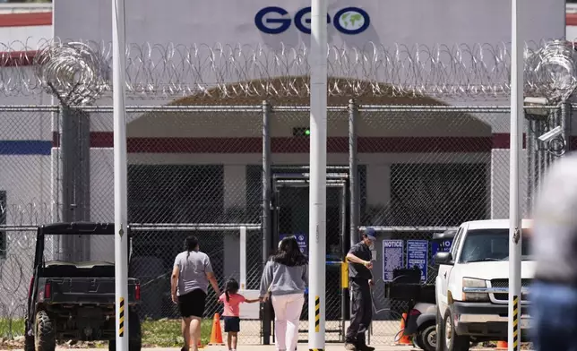 Visitors walk into the Central Louisiana ICE Processing Center in Jena, La., during an immigration hearing for Mahmoud Khalil, the Columbia University activist facing deportation for his role in pro-Palestinian campus protests, Friday, April 11, 2025. (AP Photo/Gerald Herbert)