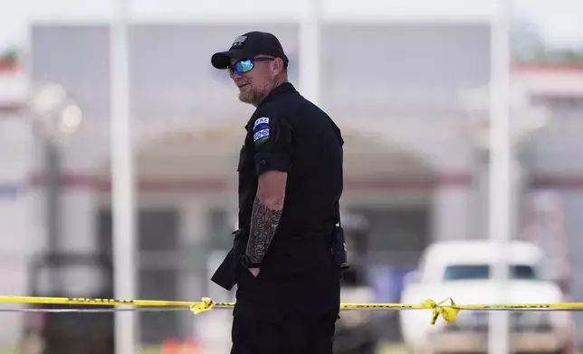 Security personnel stand guard outside the Central Louisiana Ice Processing Center in Jena, La., during an immigration hearing for Mahmoud Khalil, the Columbia University activist facing deportation for his role in pro-Palestinian campus protests, Friday, April 11, 2025. (AP Photo/Gerald Herbert)