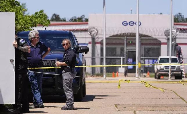 Security personnel stand post outside the Central Louisiana ICE Processing Center in Jena, La., during an immigration hearing for Mahmoud Khalil, the Columbia University activist facing deportation for his role in pro-Palestinian campus protests, Friday, April 11, 2025. (AP Photo/Gerald Herbert)