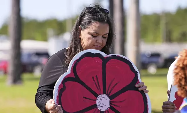 A supporter holds a sign outside the Central Louisiana ICE Processing Center in Jena, La., after an immigration hearing for Mahmoud Khalil, the Columbia University activist facing deportation for his role in pro-Palestinian campus protests, Friday, April 11, 2025. (AP Photo/Gerald Herbert)