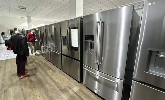 Customers shop refrigerators at a retail store in Glenview, Ill., Thursday, April 3, 2025. (AP Photo/Nam Y. Huh)