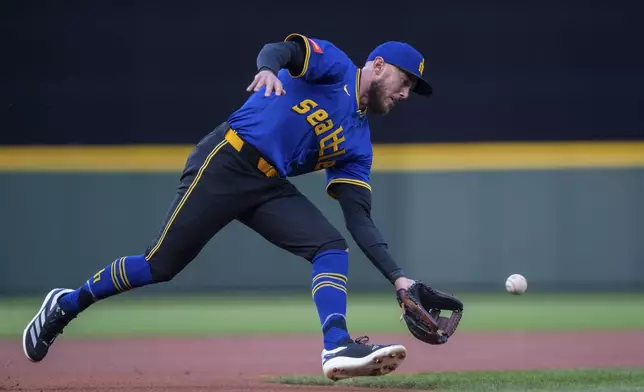 Seattle Mariners third baseman Miles Mastrobuoni fields a ground ball during the first inning of a baseball game against the Texas Rangers, Friday, April 11, 2025, in Seattle. (AP Photo/Stephen Brashear)