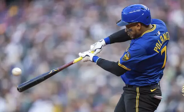 Seattle Mariners' Jorge Polanco hits a solo home run during the first inning of a baseball game against the Texas Rangers, Friday, April 11, 2025, in Seattle. (AP Photo/Stephen Brashear)