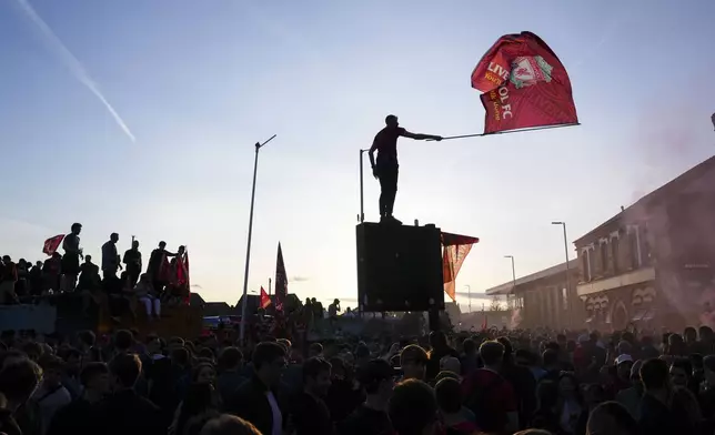 Liverpool supporters celebrate outside of Anfield stadium after their team won English Premier League soccer match against Tottenham Hotspur and clinched the Premier League title in Liverpool, England, Sunday, April 27, 2025. (AP Photo/Jon Super)
