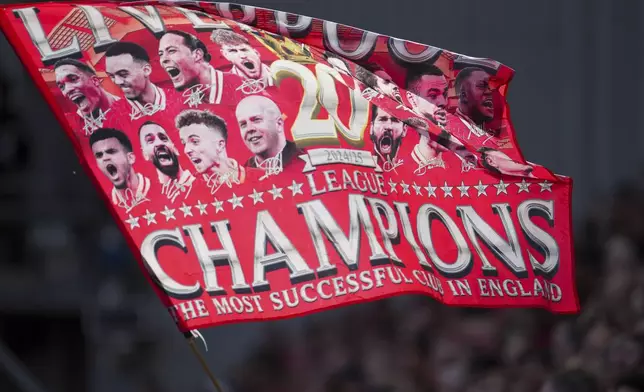 A Liverpool supporter waves a flag before the English Premier League soccer match between Liverpool and Tottenham Hotspur at Anfield in Liverpool, England, Sunday, April 27, 2025. (AP Photo/Jon Super)
