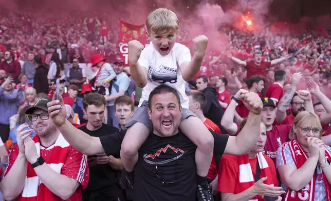 Liverpool supporters celebrate after their team won the English Premier League soccer match between Liverpool and Tottenham Hotspur and clinched the Premier League title at Anfield in Liverpool, England, Sunday, April 27, 2025. (AP Photo/Jon Super)