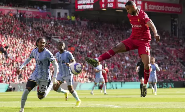 Liverpool's Cody Gakpo kicks the ball during the English Premier League soccer match between Liverpool and Tottenham Hotspur at Anfield in Liverpool, England, Sunday, April 27, 2025. (AP Photo/Jon Super)