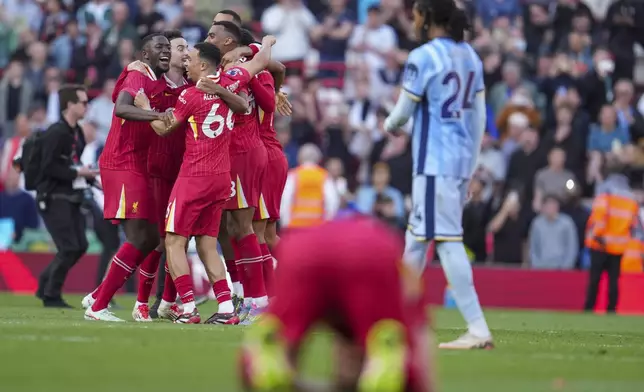 Liverpool players celebrate after winning the English Premier League soccer match between Liverpool and Tottenham Hotspur and clinching the Premier League title at Anfield in Liverpool, England, Sunday, April 27, 2025. (AP Photo/Jon Super)