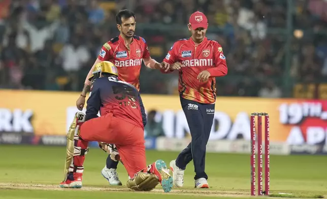 Punjab Kings' Yuzvendra Chahal, center, celebrates the dismissal of Royal Challengers Bengaluru's Jitesh Sharma, foreground, during the Indian Premier League cricket match between Royal Challengers Bengaluru and Punjab Kings at Chinnaswamy Stadium in Bengaluru, India, Friday, April 18, 2025. (AP Photo/Aijaz Rahi)
