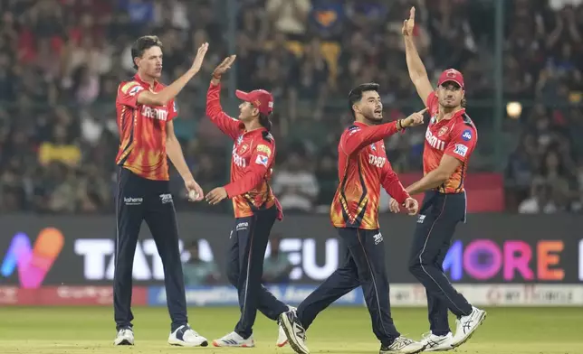 Punjab Kings' Marco Jansen, left, celebrates with teammates after the dismissal of Royal Challengers Bengaluru's Krunal Pandya during the Indian Premier League cricket match between Royal Challengers Bengaluru and Punjab Kings at Chinnaswamy Stadium in Bengaluru, India, Friday, April 18, 2025. (AP Photo/Aijaz Rahi)