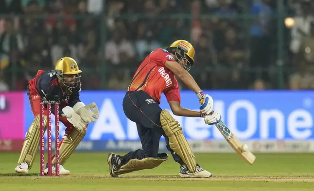 Punjab Kings' Nehal Wadhera hits a six during the Indian Premier League cricket match between Royal Challengers Bengaluru and Punjab Kings at Chinnaswamy Stadium in Bengaluru, India, Friday, April 18, 2025. (AP Photo/Aijaz Rahi)