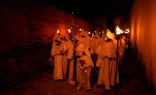 Penitents take part in the Procession of Souls on Good Friday during Holy Week in Goias, Brazil, Friday, April 18, 2025. (AP Photo/Eraldo Peres)
