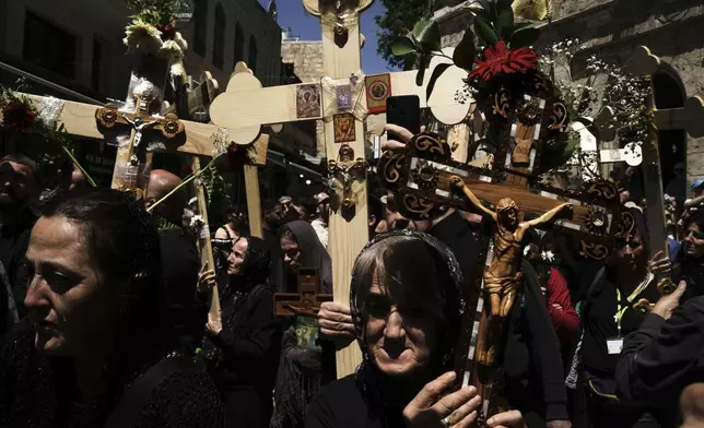 Christian pilgrims carry crosses during Good Friday procession in the Old City of Jerusalem on Friday, April 18, 2025. (AP Photo/Leo Correa)
