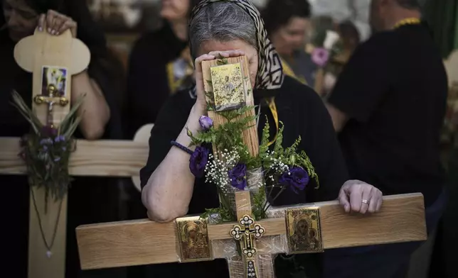 Christian pilgrims hold crosses during Good Friday procession in the Old City of Jerusalem on Friday, April 18, 2025. (AP Photo/Leo Correa)