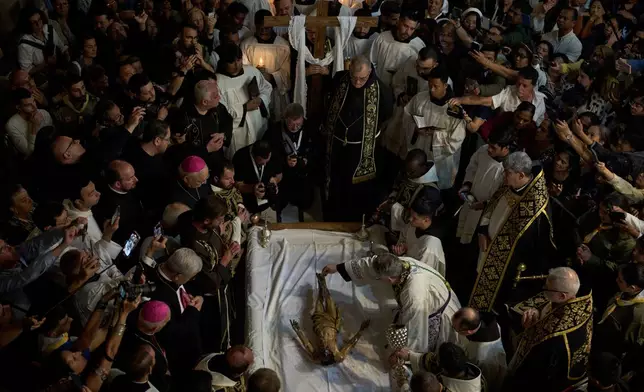 Catholic clergymen take part in a Good Friday ceremony reenacting the funeral of Jesus Christ at the Church of the Holy Sepulcher, the site where according to tradition Jesus was crucified and buried, in the Old City of Jerusalem on Friday, April 18, 2025. (AP Photo/Leo Correa)