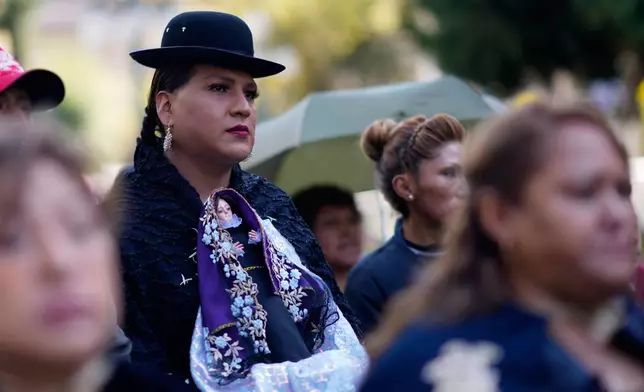 A person holding a statue of the Virgin Mary walks in a Good Friday procession during Holy Week in La Paz, Bolivia, Friday, April 18, 2025. (AP Photo/Juan Karita)