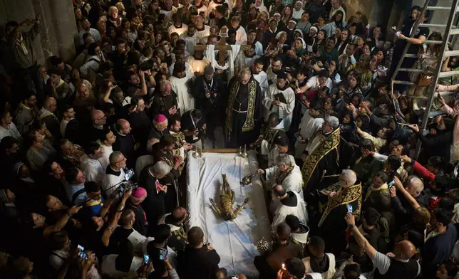 Catholic clergymen take part in a Good Friday ceremony reenacting the funeral of Jesus Christ at the Church of the Holy Sepulcher, the site where according to tradition Jesus was crucified and buried, in the Old City of Jerusalem on Friday, April 18, 2025. (AP Photo/Leo Correa)