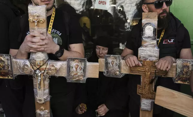 Christian pilgrims hold crosses during Good Friday procession in the Old City of Jerusalem on Friday, April 18, 2025. (AP Photo/Mahmoud Illean)