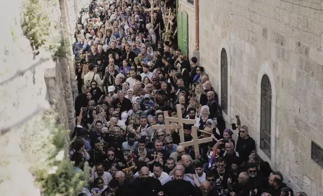 Christian pilgrims carry crosses during Good Friday procession in the Old City of Jerusalem on Friday, April 18, 2025. (AP Photo/Mahmoud Illean)