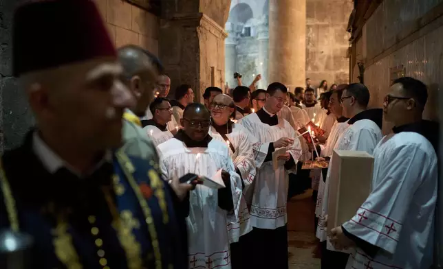 Catholic clergymen take part in a Good Friday ceremony reenacting the funeral of Jesus Christ at the Church of the Holy Sepulcher, the site where according to tradition Jesus was crucified and buried, in the Old City of Jerusalem on Friday, April 18, 2025. (AP Photo/Leo Correa)