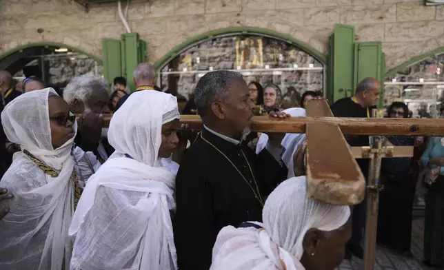 Christian pilgrims carry crosses during Good Friday procession in the Old City of Jerusalem on Friday, April 18, 2025. (AP Photo/Mahmoud Illean)