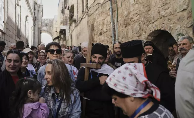 Christian pilgrims carry crosses during Good Friday procession in the Old City of Jerusalem on Friday, April 18, 2025. (AP Photo/Mahmoud Illean)