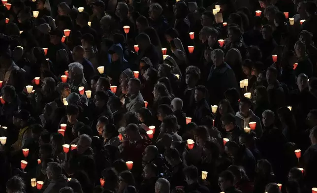 Faithful wait for the procession started inside the Colosseum during the Via Crucis (Latin for 'way of the cross') in Rome, Friday, April 18, 2025. (AP Photo/Andrew Medichini)