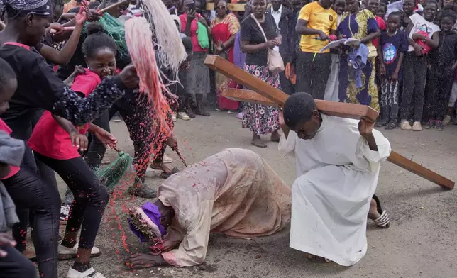Actors are whipped during a Way of the Cross reenactment of Jesus' crucifixion on Good Friday during Holy Week in the Kibera informal settlement of Nairobi, Kenya, Friday, April 18, 2025. (AP Photo/Brian Inganga)