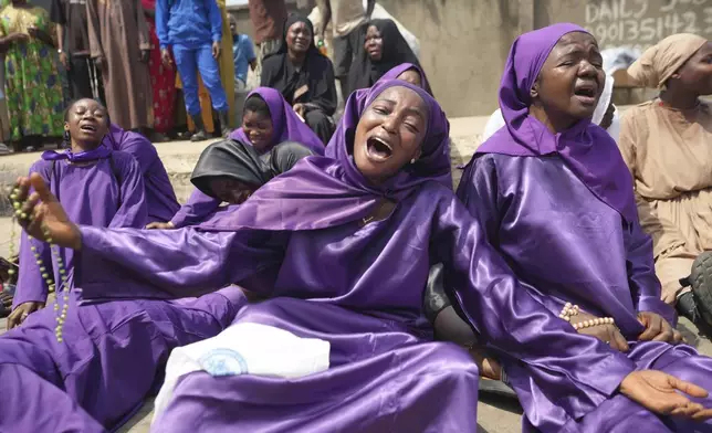 Members of the St Francis Catholic Church take part in a Way of the Cross re-enactment of the crucifixion of Jesus Christ on Good Friday during Holy Week in Lagos, Nigeria, Friday, April 18, 2025. (AP Photo/Sunday Alamba)