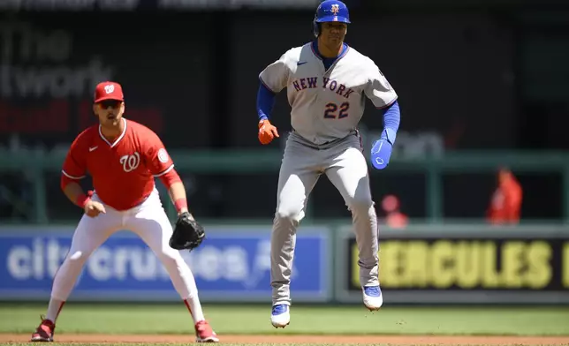 New York Mets' Juan Soto (22) takes a lead from first base in front of Washington Nationals first baseman Nathaniel Lowe, left, during the first inning of a baseball game, Sunday, April 27, 2025, in Washington. (AP Photo/Nick Wass)