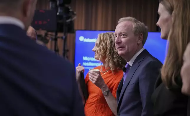 Microsoft's President Brad Smith, center, arrives for a conference on digital resilience during geopolitical volatility in Brussels, Wednesday, April 30, 2025. (AP Photo/Virginia Mayo)