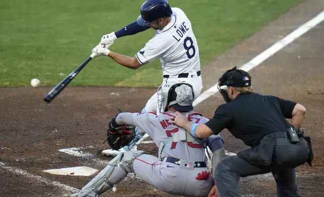 Tampa Bay Rays' Brandon Lowe (8) connects for a two-run single off Boston Red Sox pitcher Tanner Houck during the second inning of a baseball game Monday, April 14, 2025, in Tampa, Fla. (AP Photo/Chris O'Meara)
