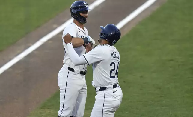 Tampa Bay Rays' Kameron Misner celebrates his two-run home run off Boston Red Sox pitcher Tanner Houck with Christopher Morel (24) during the second inning of a baseball game Monday, April 14, 2025, in Tampa, Fla. (AP Photo/Chris O'Meara)