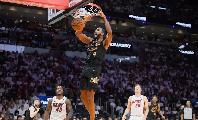 Cleveland Cavaliers forward Evan Mobley (4) scores against the Miami Heat during the second half in Game 3 of an NBA basketball first-round playoff series, Saturday, April 26, 2025, in Miami. (AP Photo/Michael Laughlin)