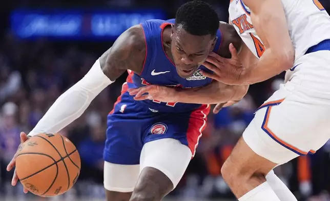 Detroit Pistons guard Dennis Schroder (17), left, moves past New York Knicks guard Pacome Dadiet (4), right, during the first half of Game 1 in an NBA basketball first-round playoff series, Saturday, April 19, 2025, in New York. (AP Photo/Julia Demaree Nikhinson)
