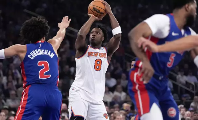 New York Knicks forward OG Anunoby (8) shoots past Detroit Pistons guard Cade Cunningham (2) during the first half of Game 1 in an NBA basketball first-round playoff series, Saturday, April 19, 2025, in New York. (AP Photo/Julia Demaree Nikhinson)