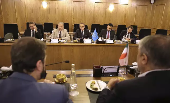In this photo released by the Atomic Energy Organisation of Iran, International Atomic Energy Agency (IAEA) Director General, Rafael Mariano Grossi, rear center, and his delegation attend a meeting with head of the Atomic Energy Organization of Iran, Mohammad Eslami, foreground right, and his delegation in Tehran, Iran, Thursday, April 17, 2025. (Atomic Energy Organisation of Iran via AP)