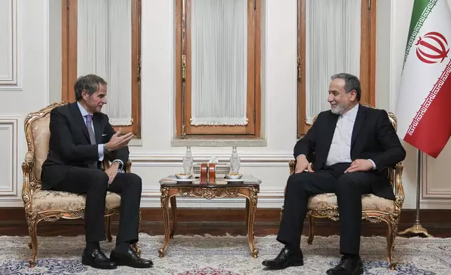 In this photo released by the Iranian Foreign Ministry, Foreign Minister Abbas Araghchi, right, listens to International Atomic Energy Agency (IAEA) Director General Rafael Mariano Grossi during their meeting in Tehran, Iran, Wednesday, April 16, 2025. (Iranian Foreign Ministry via AP)