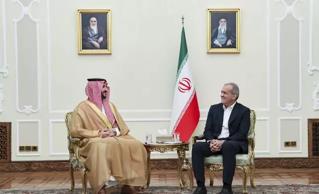 In this photo released by the Iranian Presidency Office, President Masoud Pezeshkian, right, meets with Saudi Arabia's Defense Minister Prince Khalid bin Salman, in Tehran, Iran, Thursday, April 17, 2025. (Iranian Presidency Office via AP)