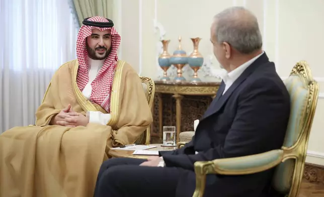 In this photo released by the Iranian Presidency Office, Saudi Arabia's Defense Minister Prince Khalid bin Salman, left, speaks with President Masoud Pezeshkian during their meeting, in Tehran, Iran, Thursday, April 17, 2025. (Iranian Presidency Office via AP)
