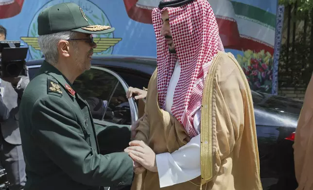 This image released by the public relation of the General Staff of Iran's Armed Forces, Saudi Arabia's Defense Minister Prince Khalid bin Salman, right, is welcomed by Chief of the General Staff of Iran's Armed Forces Gen. Mohammad Hossein Bagheri during a welcoming ceremony in Tehran, Thursday, April 17, 2025. (Public relation of the General Staff of Iran's Armed Forces via AP)