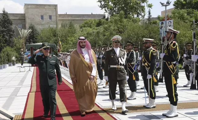 This image released by the public relations of the General Staff of Iran's Armed Forces, Saudi Arabia's Defense Minister Prince Khalid bin Salman, second left, reviews an honor guard as he is accompanied by Chief of the General Staff of Iran's Armed Forces Gen. Mohammad Hossein Bagheri, left, during a welcoming ceremony in Tehran, Thursday, April 17, 2025. ( Public relations of the General Staff of Iran's Armed Forces via AP)