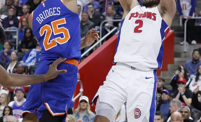 Detroit Pistons guard Cade Cunningham (2) takes a jump shot against New York Knicks forward Mikal Bridges (25) during the second half of Game 4 of an NBA basketball first-round playoff series Sunday, April 27, 2025, in Detroit. (AP Photo/Duane Burleson)