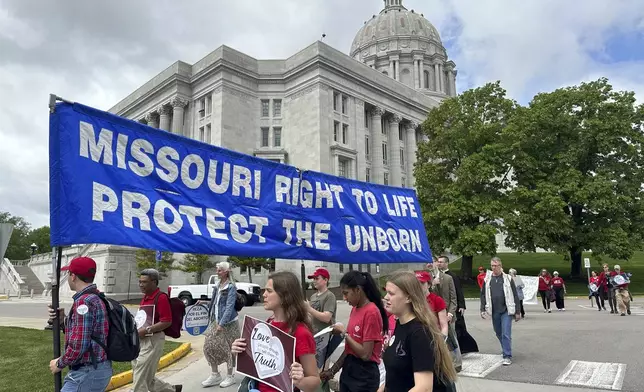 Participants in the Midwest March for Life walk past the Missouri Capitol on May 1, 2025, in Jefferson City, Mo. (AP Photo/David A. Lieb)