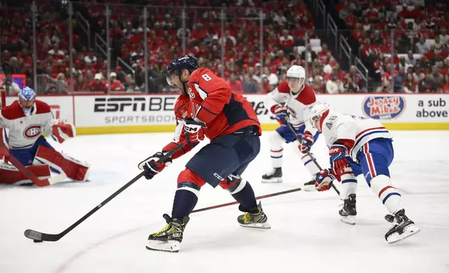 Washington Capitals left wing Alex Ovechkin (8) skates with the puck past Montreal Canadiens defenseman Lane Hutson (48) in the first period of Game 5 of a first-round NHL hockey playoff series Wednesday, April 30, 2025, in Washington. (AP Photo/Nick Wass)