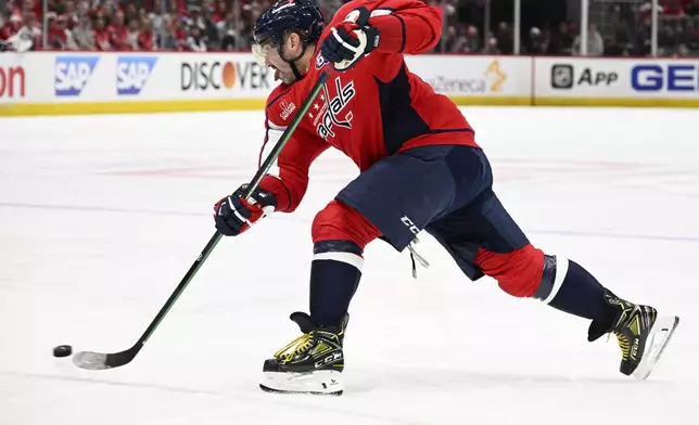 Washington Capitals left wing Alex Ovechkin (8) shoots the puck in the first period of Game 2 of a first-round NHL hockey playoff series against the Montreal Canadiens Wednesday, April 23, 2025, in Washington. (AP Photo/Nick Wass)