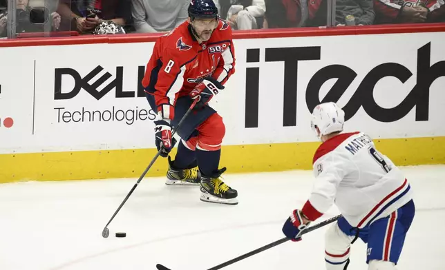 Washington Capitals left wing Alex Ovechkin, top, skates with the puck against Montreal Canadiens defenseman Mike Matheson, bottom, in the third period of Game 2 of a first-round NHL hockey playoff series Wednesday, April 23, 2025, in Washington. (AP Photo/Nick Wass)