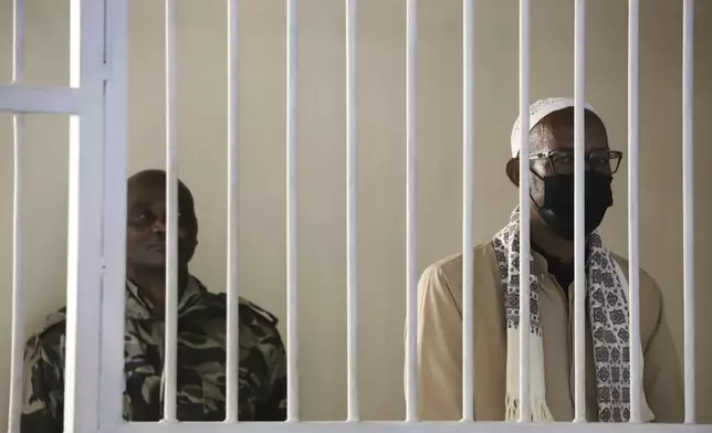 Mohammed Abdi Ali, right, stands in the dock at the Kahawa Law Courts, Nairobi, Kenya Thursday, May 22, 2025. (AP Photo/Andrew Kasuku)