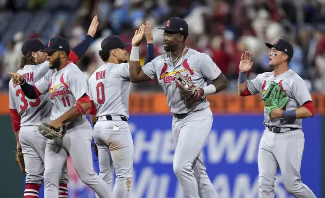 St. Louis Cardinals players celebrate after winning a baseball game against the Philadelphia Phillies Monday, May 12, 2025, in Philadelphia. (AP Photo/Matt Slocum)