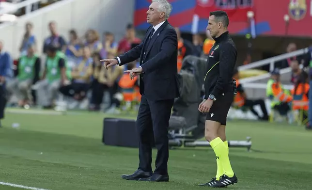 Real Madrid's head coach Carlo Ancelotti gives instructions during the La Liga soccer match between Barcelona and Real Madrid in Barcelona, Spain, Sunday, May 11, 2025. AP Photo/Joan Monfort)